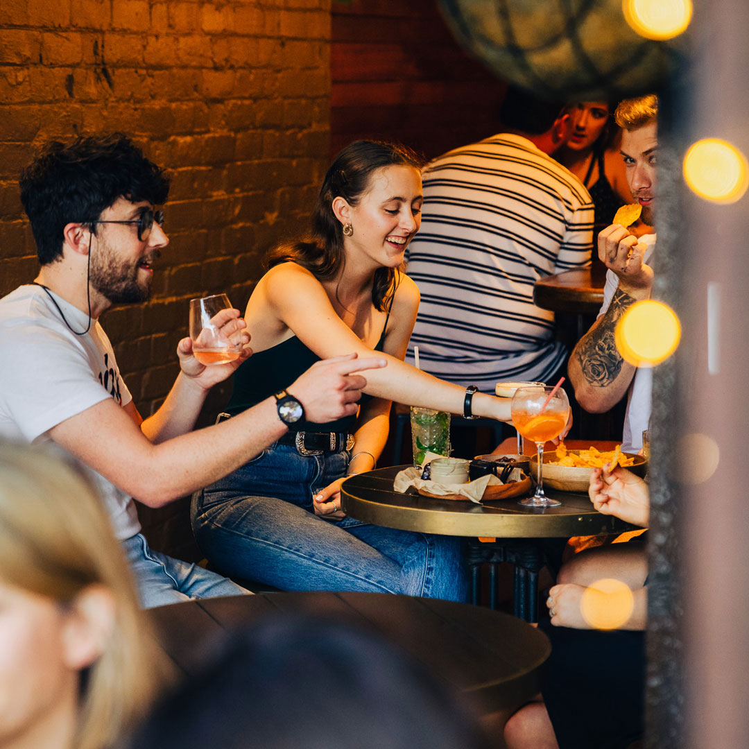 Friends enjoying food and drink in Ponsonby