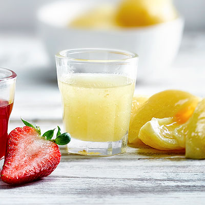 Image of a shot glass of preserved lemon syrup