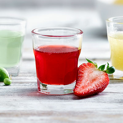 image of shot glass of strawberry syrup